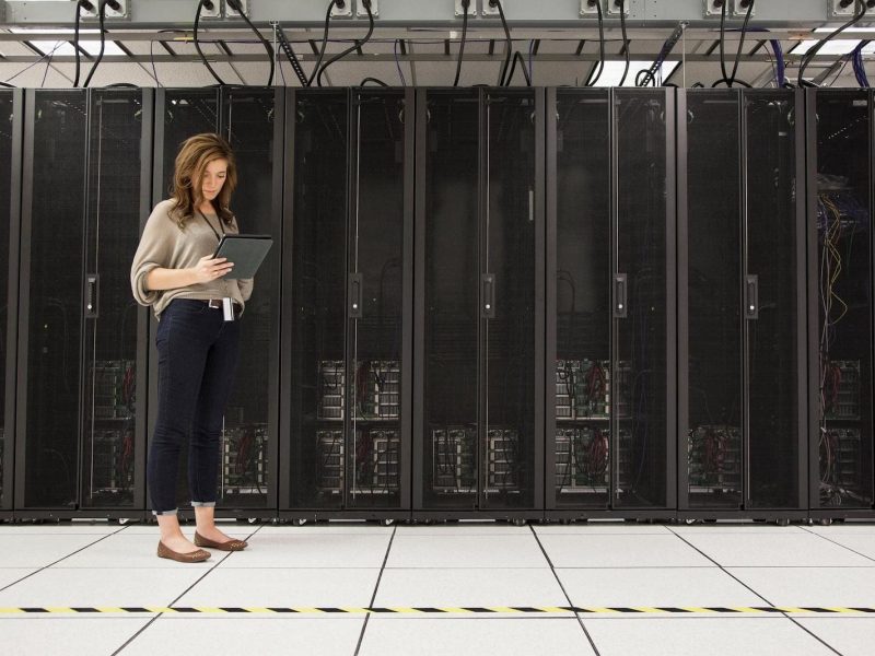 5962-mixed-race-businesswoman-using-tablet-computer-in-server-room-b2b